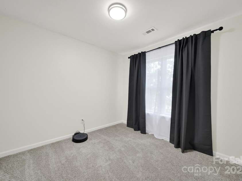 7801 Bella Vista Court, Charlotte, NC 28216.  MLS# CAR4285247, YatesRealty ID 29767. Bedroom 2 has neutral paint and carpeting with window treatments.