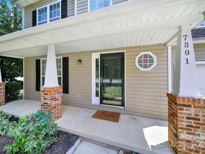 7801 Bella Vista Court, Charlotte, NC 28216.  MLS# CAR4285247, YatesRealty ID 29767. Front porch has plenty of room for rocking chairs!