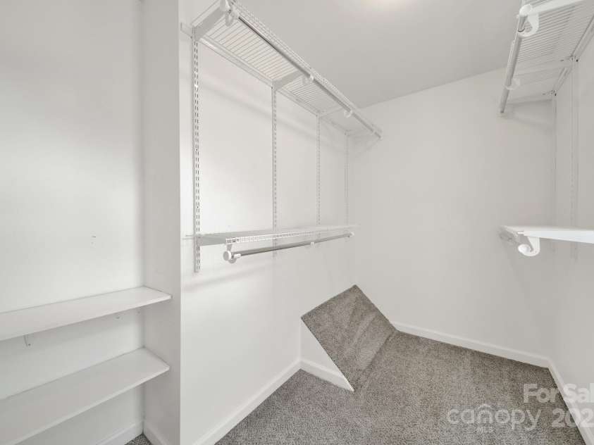 7801 Bella Vista Court, Charlotte, NC 28216.  MLS# CAR4285247, YatesRealty ID 29767. Large walk in closet features LED lighting, window, and plenty of space for your needs.