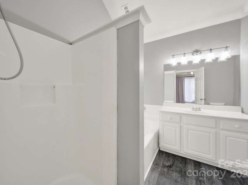 7801 Bella Vista Court, Charlotte, NC 28216.  MLS# CAR4285247, YatesRealty ID 29767. Primary Bathroom features separate shower and bath, and LED lighting.