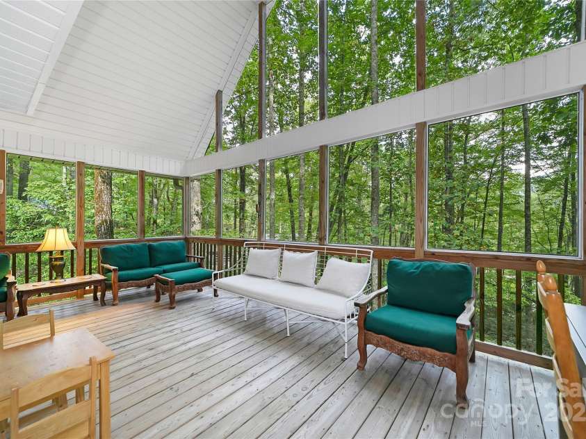 557 Country Club Estates Drive, Sapphire, NC 28774.  MLS# CAR4302980, YatesRealty ID 2977. Back deck / porch is light and bright and puts you in the 