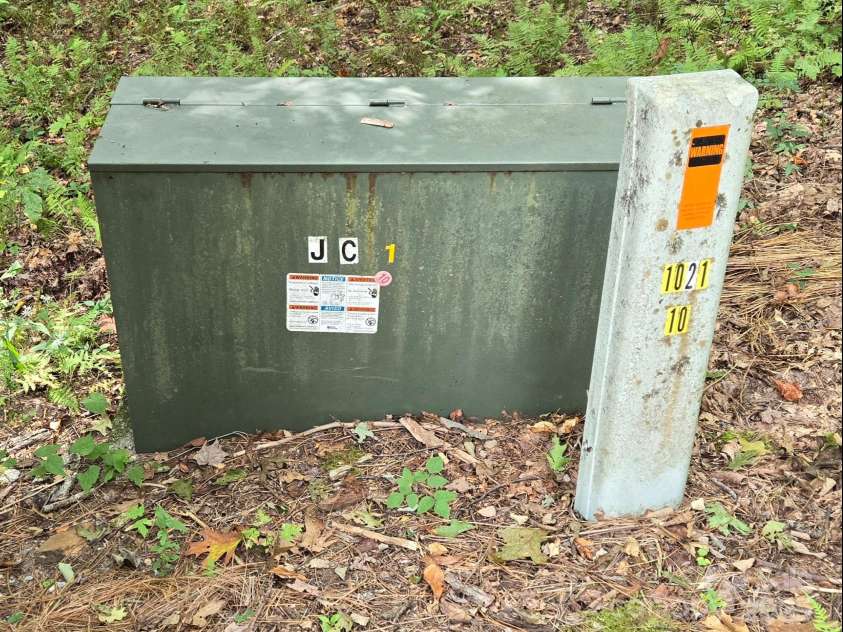 557 Country Club Estates Drive, Sapphire, NC 28774.  MLS# CAR4302980, YatesRealty ID 2977. Electrical Transformer here at the culdesac, serving power and communications underground in the entire development.