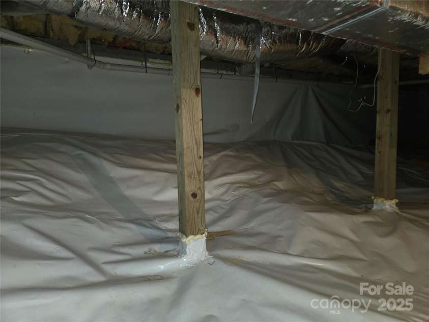 557 Country Club Estates Drive, Sapphire, NC 28774.  MLS# CAR4302980, YatesRealty ID 2977. Encapsulated large high crawlspace under the house.