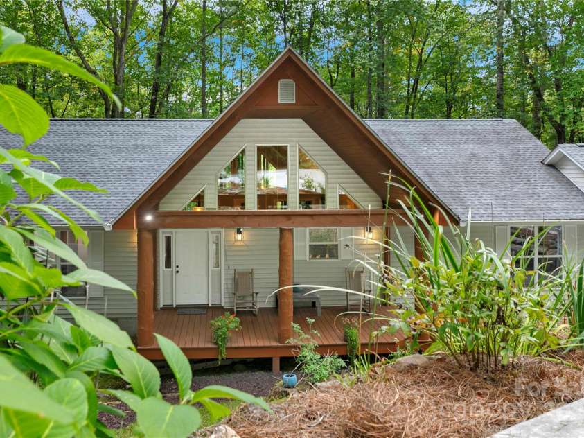 557 Country Club Estates Drive, Sapphire, NC 28774.  MLS# CAR4302980, YatesRealty ID 2977. House Front Porch as seen from the driveway. Great landscaping along the driveway, and above its rock wall. 