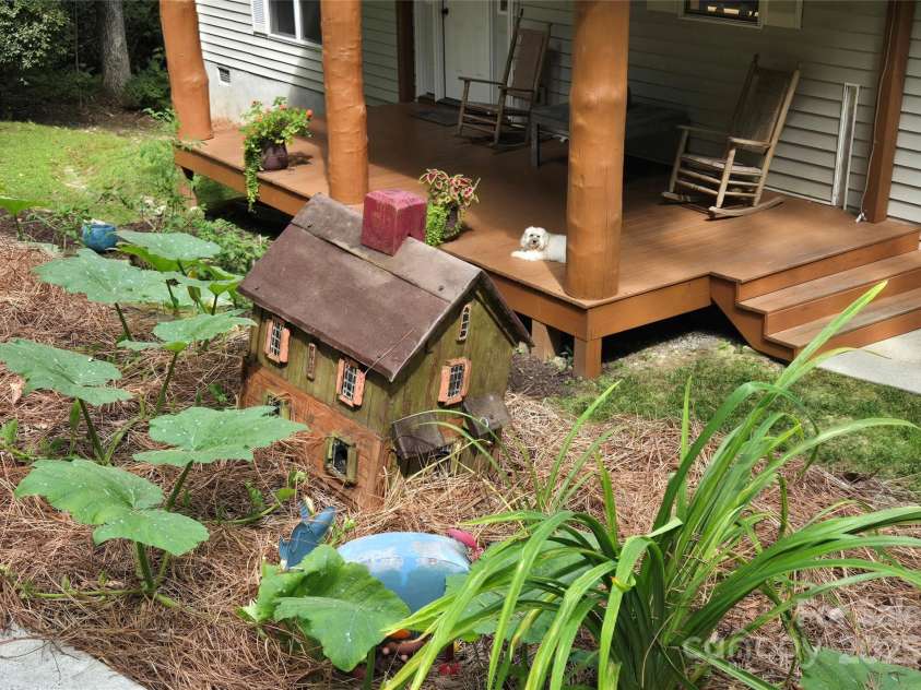 557 Country Club Estates Drive, Sapphire, NC 28774.  MLS# CAR4302980, YatesRealty ID 2977. House Front Porch seen from the bottom of driveway. Little 'Macie' waits to greet you!