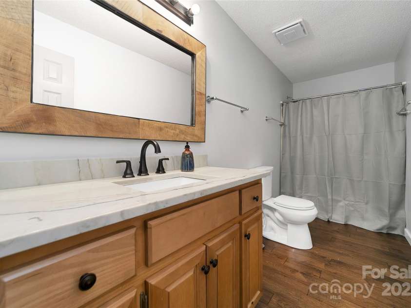 557 Country Club Estates Drive, Sapphire, NC 28774.  MLS# CAR4302980, YatesRealty ID 2977. Large and stylish second bathroom for the 2nd and 3rd bedrooms.