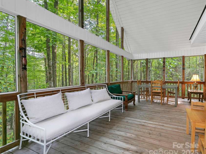 557 Country Club Estates Drive, Sapphire, NC 28774.  MLS# CAR4302980, YatesRealty ID 2977. Read a book, relax or nap! Back deck / porch is light and bright and puts you in the 
