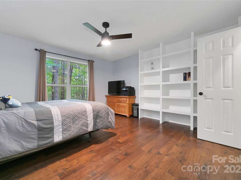 557 Country Club Estates Drive, Sapphire, NC 28774.  MLS# CAR4302980, YatesRealty ID 2977. The 3rd, rear, bedroom has built in shelving features, as well as its own closet.