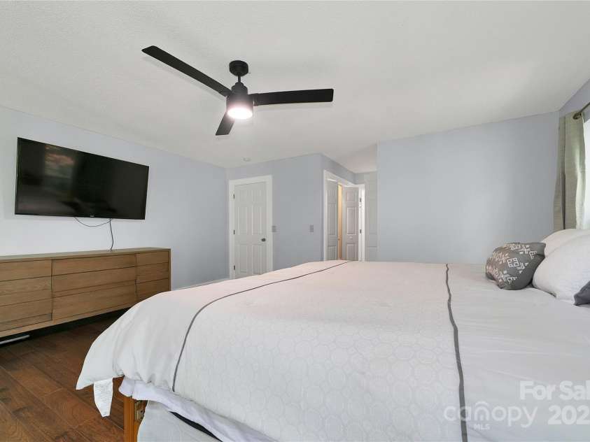 557 Country Club Estates Drive, Sapphire, NC 28774.  MLS# CAR4302980, YatesRealty ID 2977. The primary bedroom has plenty of closet space as you enter its bath / closet area.