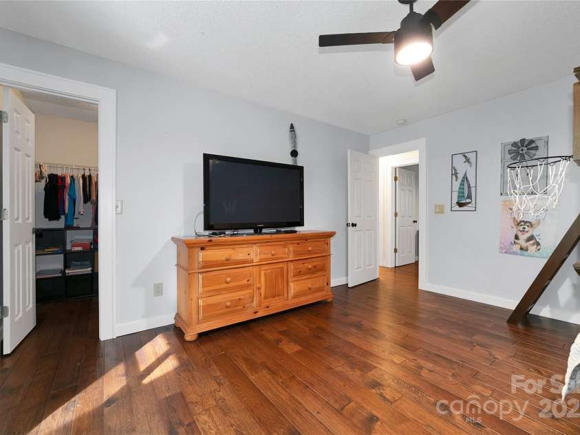 557 Country Club Estates Drive, Sapphire, NC 28774.  MLS# CAR4302980, YatesRealty ID 2977. This front, 2nd, bedroom features its own walk-in closet, and those same beautiful wood floors.
