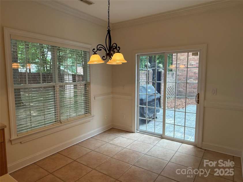 9177 Bonnie Briar Circle, Charlotte, NC 28277.  MLS# CAR4267852, YatesRealty ID 29784. Breakfast area looks out to wooded back area and the enclosed courtyard/patio area