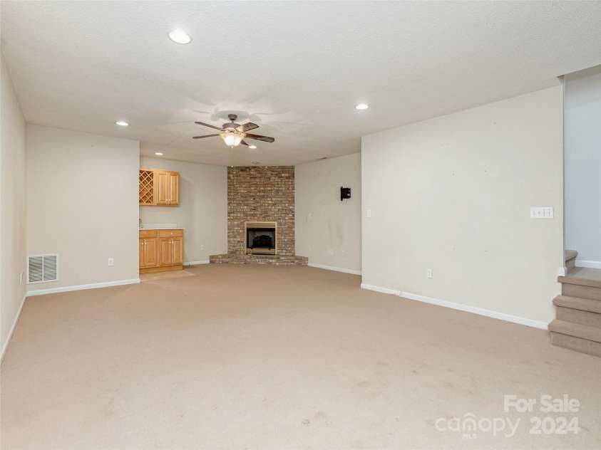 39 Apple Creek Lane, Hendersonville, NC 28792.  MLS# CAR4171791, YatesRealty ID 2979. Downstairs Fireplace In Flex Room