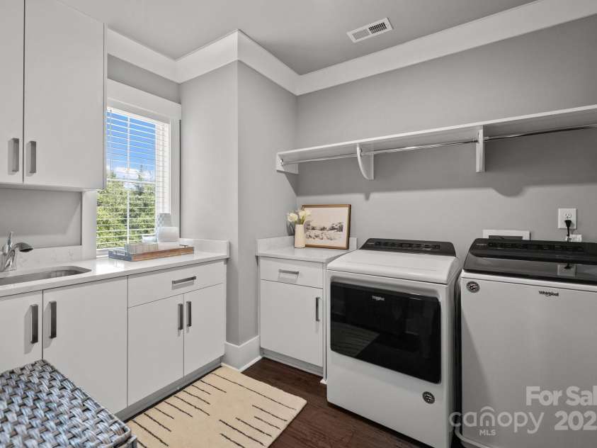 7919 Rea View Court, Charlotte, NC 28226.  MLS# CAR4279811, YatesRealty ID 29798. Laundry with Sink, Window, Cabinets and Shelving.