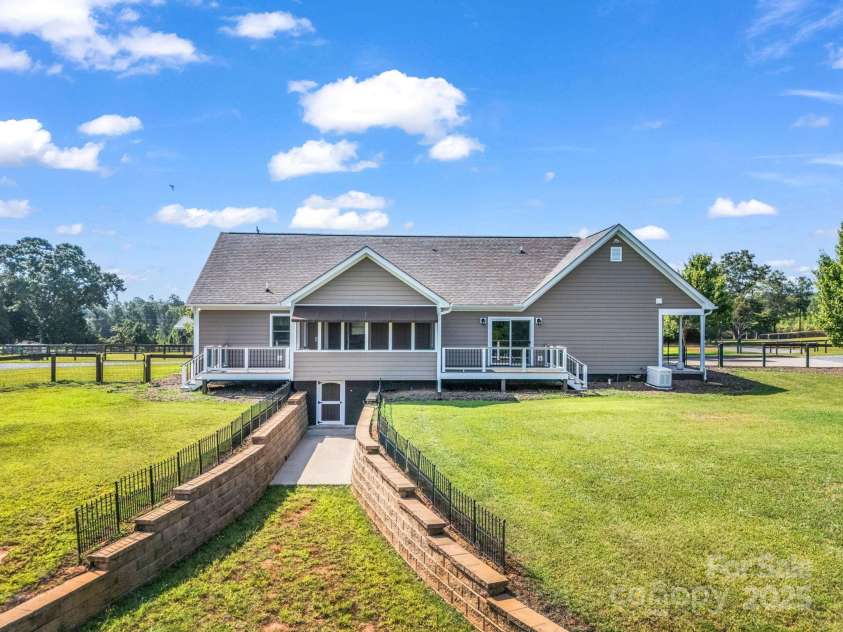 609 Green Creek Drive, Columbus, NC 28722.  MLS# CAR4288033, YatesRealty ID 29805. Back of house & entrance to crawl space