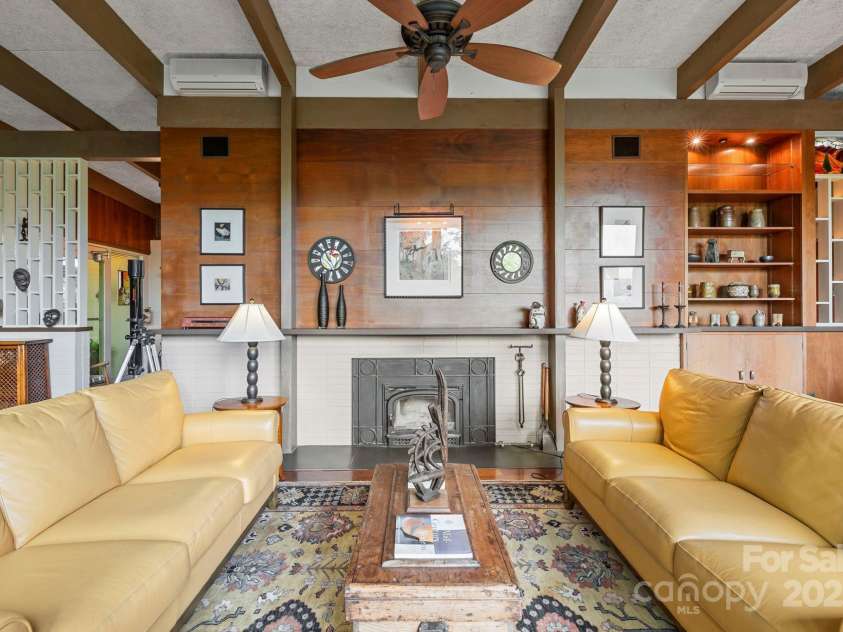 21 Rhododendron Road, Black Mountain, NC 28711.  MLS# CAR4266753, YatesRealty ID 29832. Living Room w/ wood fireplace and wood burning stove insert
