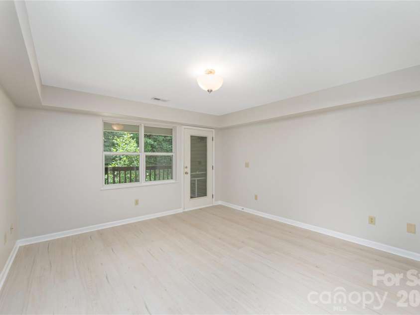409 Carlyle Way, Asheville, NC 28803.  MLS# CAR4392265, YatesRealty ID 29842. Living Room toward rear deck