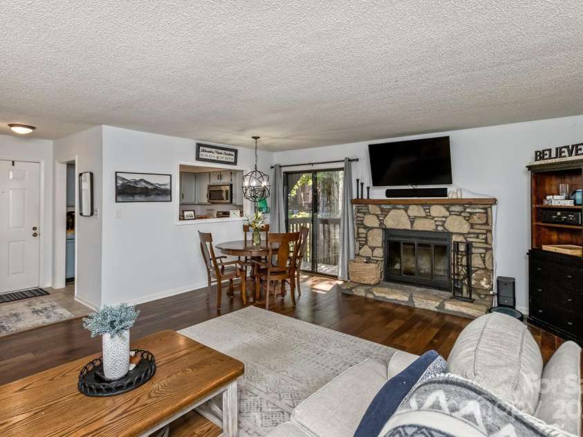 107 Cedar Forest Trail, Asheville, NC 28803.  MLS# CAR4276126, YatesRealty ID 29863. Front door, buffet window in the dining area and spacious living room, cozy fireplace