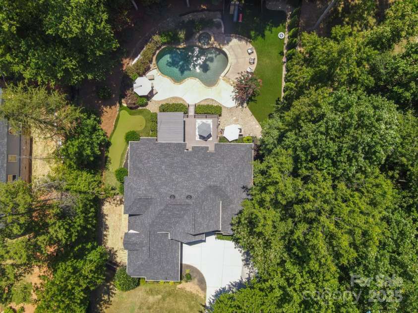 7882 Butternut Lane, Denver, NC 28037.  MLS# CAR4285542, YatesRealty ID 29872. Putting green on left side of house