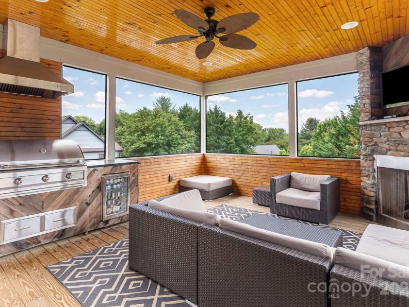 19 Carrolls Place Court, Mills River, NC 28759.  MLS# CAR4282064, YatesRealty ID 29890. All-season 285sqft screened porch with gas fireplace, tv hook up, recessed lighting and Artisan Professional grill + beverage fridge