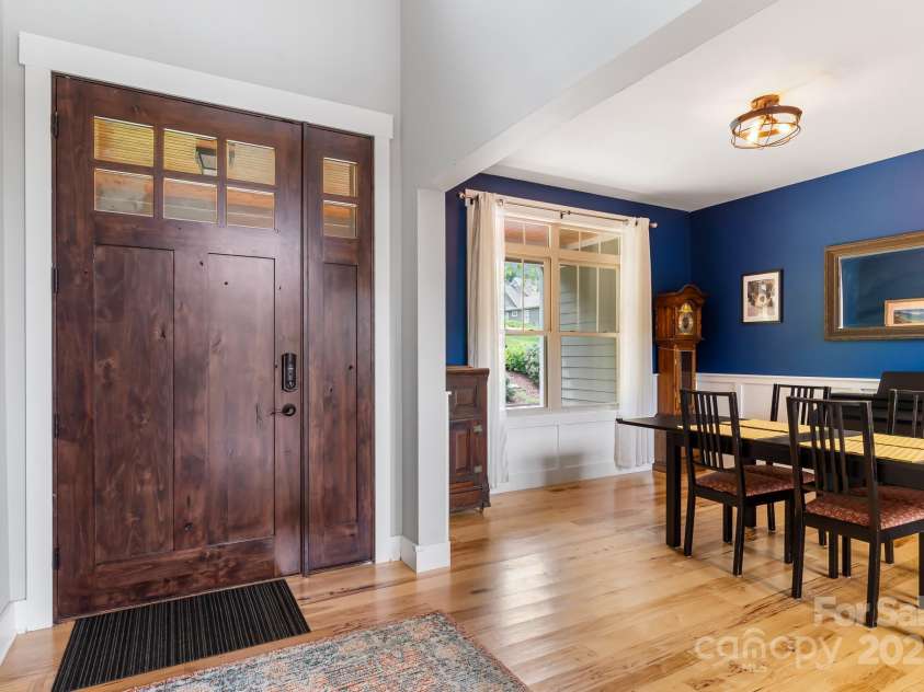 19 Carrolls Place Court, Mills River, NC 28759.  MLS# CAR4282064, YatesRealty ID 29890. Entry and dining space with a gorgeous knotty alder 8' door