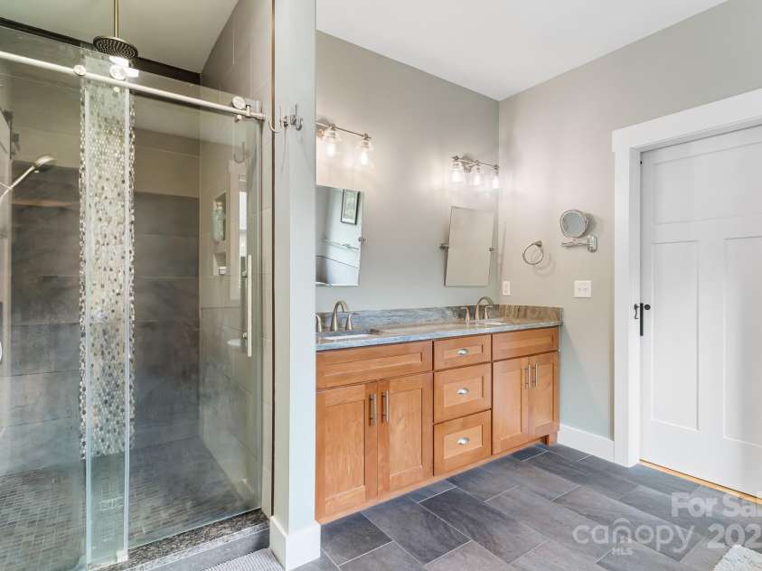 19 Carrolls Place Court, Mills River, NC 28759.  MLS# CAR4282064, YatesRealty ID 29890. Primary bathroom with walk-in shower with dual shower heads including rain shower