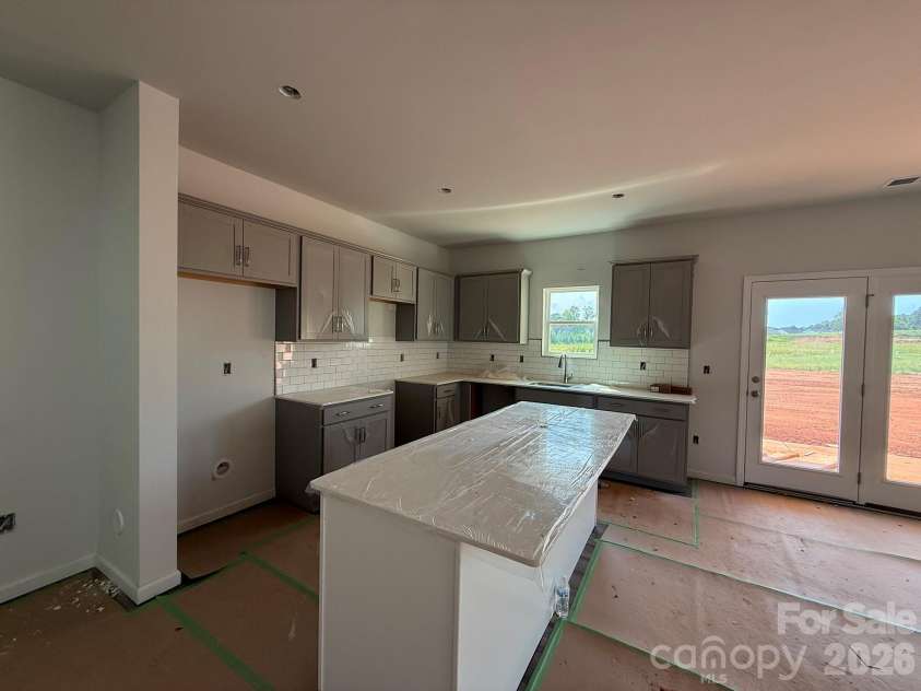 4017 Juno Drive, Charlotte, NC 28215.  MLS# CAR4392598, YatesRealty ID 29895. Kitchen features Gray Surround cabinets and White Island with Quartz countertops