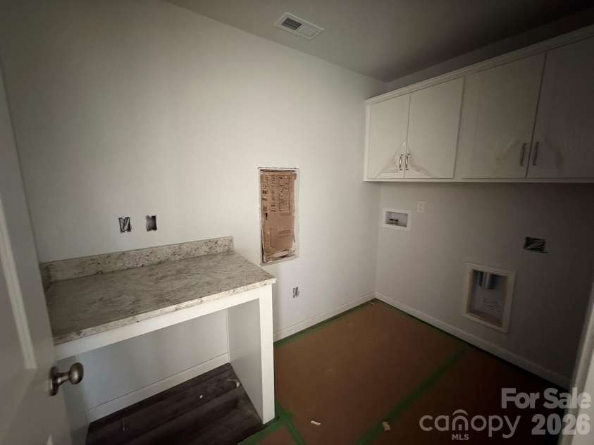 4017 Juno Drive, Charlotte, NC 28215.  MLS# CAR4392598, YatesRealty ID 29895. Laundry Room with Cabinets and folding station