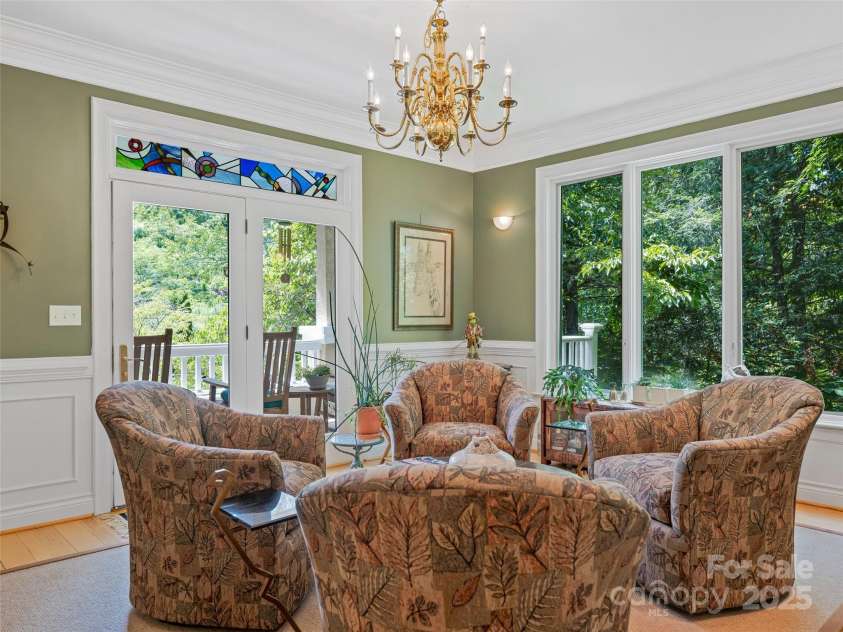 212 Plains Drive, Asheville, NC 28803.  MLS# CAR4284711, YatesRealty ID 29898. Living room with Carl Powell stained glass transom