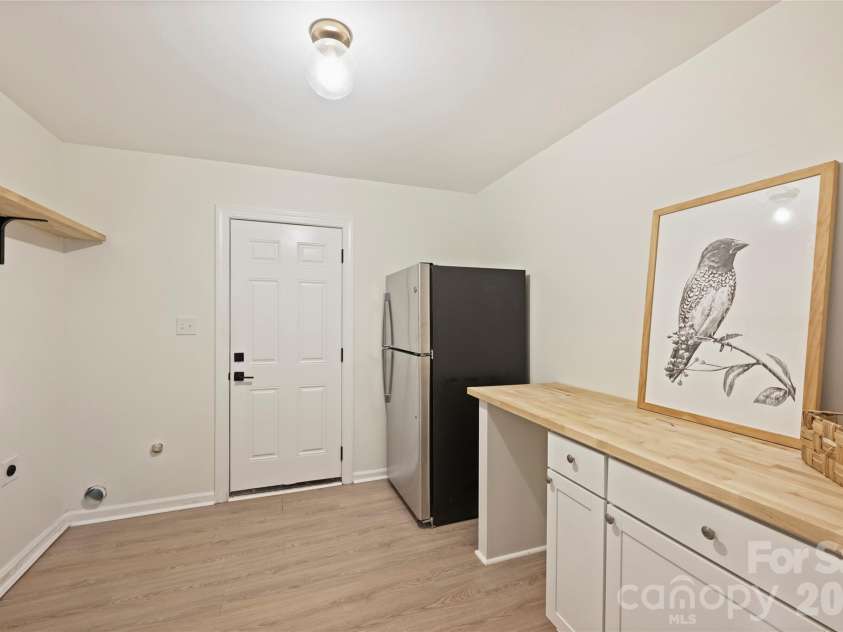7420 Castlebar Road, Charlotte, NC 28270.  MLS# CAR4382970, YatesRealty ID 29905. Dedicated launry room on lower level with extra refrigerator and access to backyard.