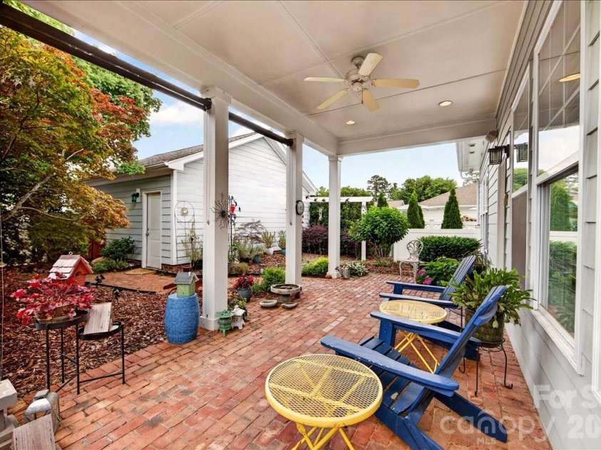 12422 Brenthaven Drive, Davidson, NC 28036.  MLS# CAR4387323, YatesRealty ID 29933. Covered patio overlooking courtyard with rustic brick pavers.