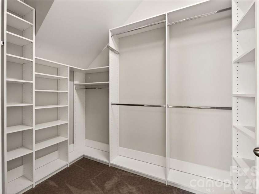 12422 Brenthaven Drive, Davidson, NC 28036.  MLS# CAR4387323, YatesRealty ID 29933. Large primary closet with built-in shelving.