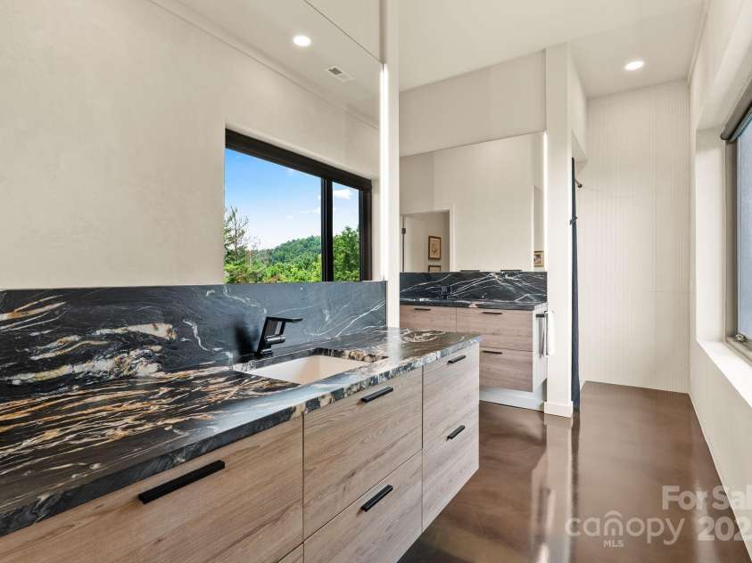 1045 & 1047 Graham Road, Marshall, NC 28753.  MLS# CAR4280943, YatesRealty ID 29941. Primary bathroom w/separate vanities and custom cabinetry