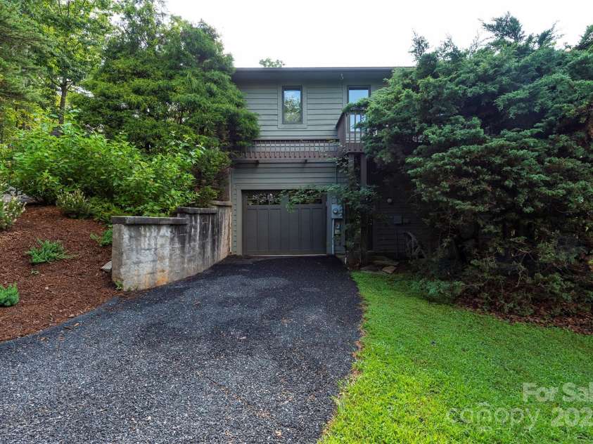 4 Galax Lane, Black Mountain, NC 28711.  MLS# CAR4286030, YatesRealty ID 29947. Lower drive to garage, workshop, bedrooms, bath, and family room.