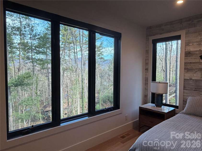 42 Spring Cove Road, Asheville, NC 28804.  MLS# CAR4246585, YatesRealty ID 29948. Beautiful seasonal views abound! This vista can be enjoyed from the main floor primary bedroom.
