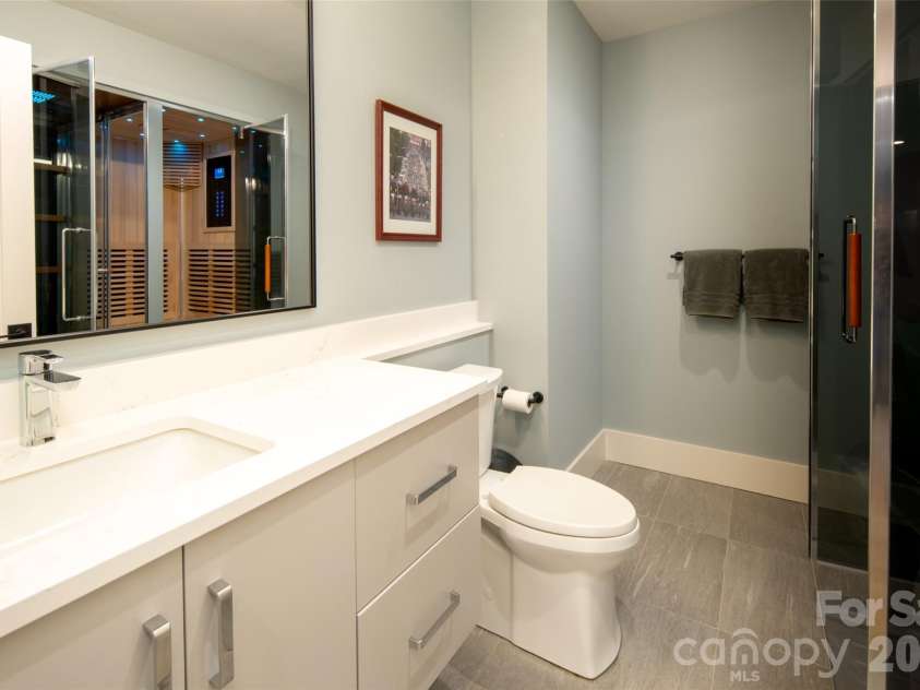42 Spring Cove Road, Asheville, NC 28804.  MLS# CAR4246585, YatesRealty ID 29948. Ensuite bath for lower level primary can also be accessed via hallway for guests while entertaining.