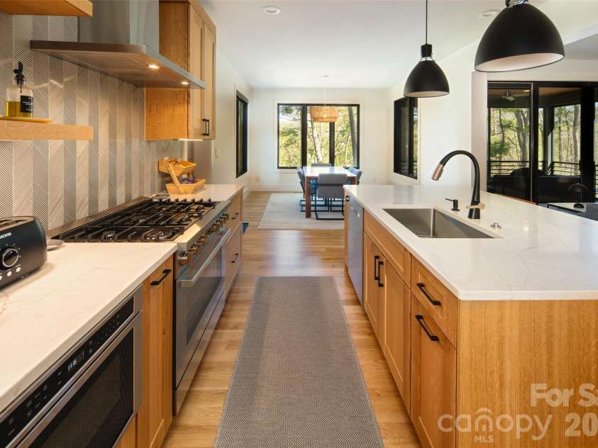 42 Spring Cove Road, Asheville, NC 28804.  MLS# CAR4246585, YatesRealty ID 29948. Large kitchen opens to spacious dining room/area with walls of windows bringing in light and gorgeous views.
