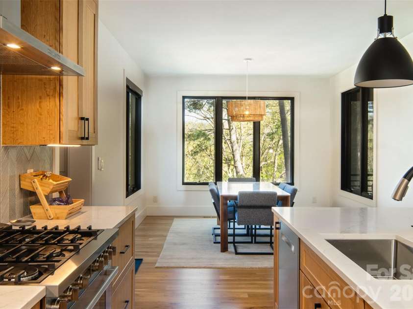 42 Spring Cove Road, Asheville, NC 28804.  MLS# CAR4246585, YatesRealty ID 29948. Light streams through the expansive windows on all three walls of the spacious dining room.
