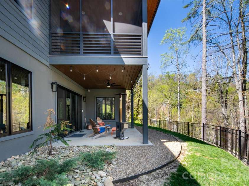 42 Spring Cove Road, Asheville, NC 28804.  MLS# CAR4246585, YatesRealty ID 29948. View of lower level covered porch and beautiful outdoor space.
