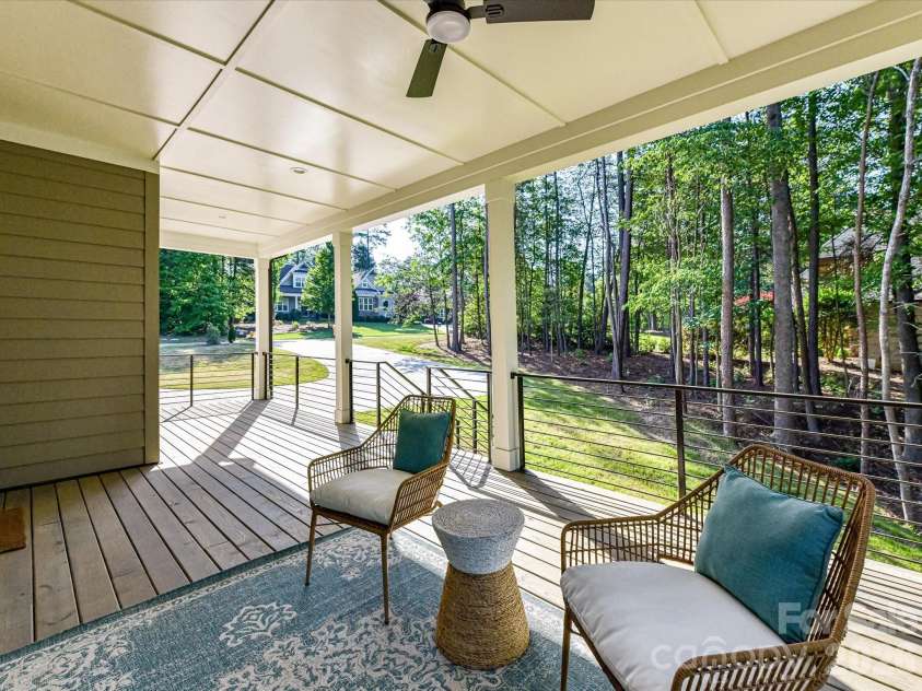 4609 Firethorn Court, Denver, NC 28037.  MLS# CAR4358984, YatesRealty ID 29951. Spacious covered deck overlooking a private wooded backdrop, perfect for relaxing, entertaining, and enjoying peaceful outdoor living year-round.