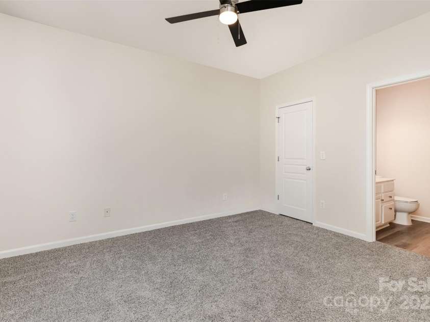 8390 Chaceview Court, Charlotte, NC 28269.  MLS# CAR4283871, YatesRealty ID 29962. Main level primary bedroom