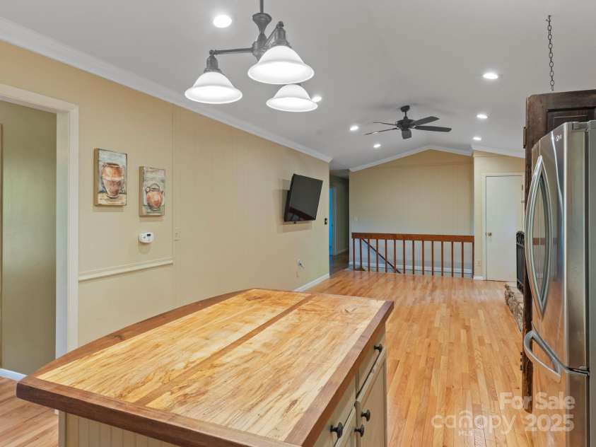 6 Wilderness Cove Road, Asheville, NC 28804.  MLS# CAR4274846, YatesRealty ID 29979. Kitchen area looking to the gas log living room.