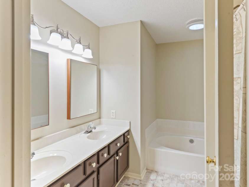 6 Wilderness Cove Road, Asheville, NC 28804.  MLS# CAR4274846, YatesRealty ID 29979. Primary bathroom -note the awesome solar tube for natural light-