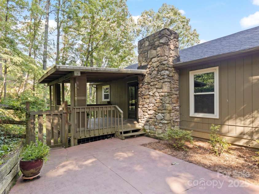 6 Wilderness Cove Road, Asheville, NC 28804.  MLS# CAR4274846, YatesRealty ID 29979. The back entrance has a serene porch with a flat patio area for gilling.