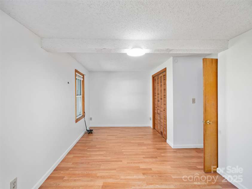 384 Flat Creek Road, Fairview, NC 28730.  MLS# CAR4240696, YatesRealty ID 2999. Bedroom with ensuite bath.