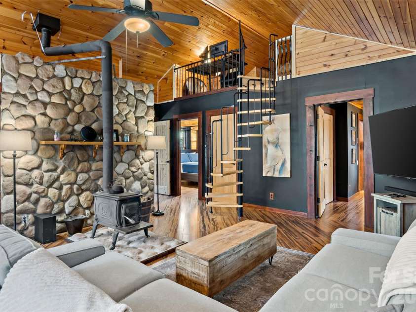 317 Chocolate Drop Circle, Union Mills, NC 28167.  MLS# CAR4337126, YatesRealty ID 3002. Living area with wood stove