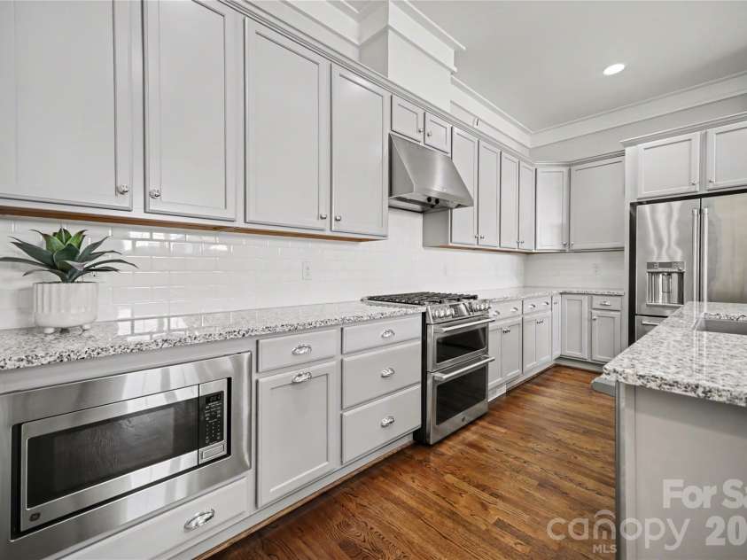 127 Inspired Way, Fort Mill, SC 29708.  MLS# CAR4369238, YatesRealty ID 30032. Double ovens, gas range, microwave and counter-depth refrigerator