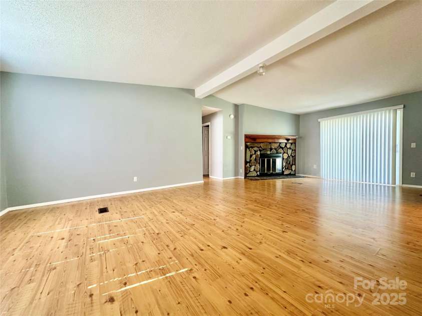 125 Pineville Road, Statesville, NC 28677.  MLS# CAR4190287, YatesRealty ID 3005. Alternate living room view with wood burning fireplace.