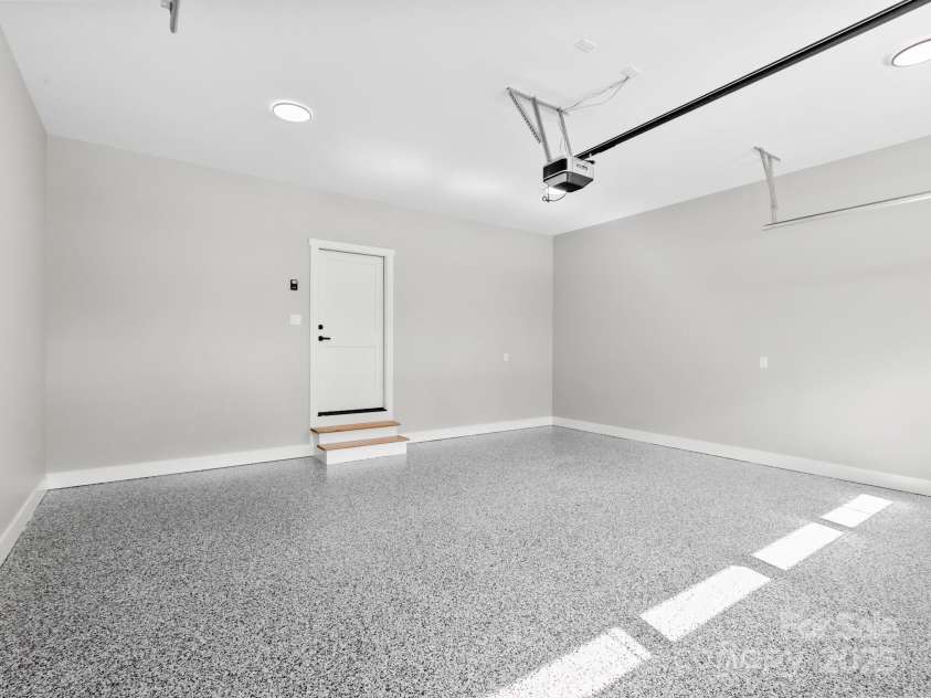 231 Asbury Road, Candler, NC 28715.  MLS# CAR4283786, YatesRealty ID 30077. Garage w/ epoxy floor