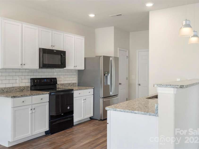 304 Ware Street, Kings Mountain, NC 28086.  MLS# CAR4282123, YatesRealty ID 30083. Fresh white cabinets, granite counters, pocket lights and pendant lights give this kitchen a modern, sleek look.