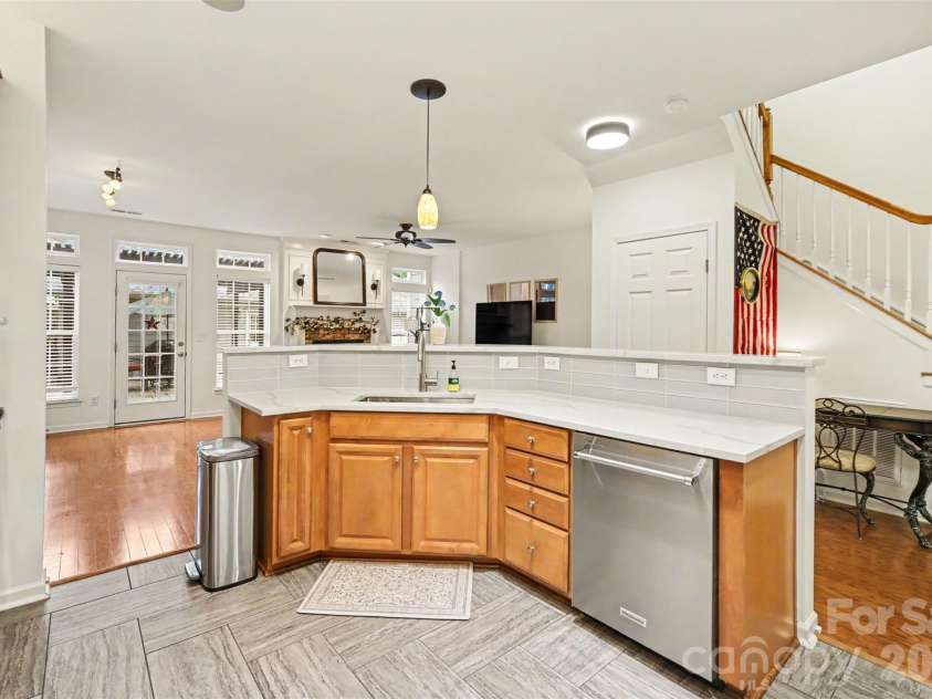 438 Magnolia Street, Davidson, NC 28036.  MLS# CAR4368147, YatesRealty ID 30083. Open island/ bar area with stainless steel appliances.